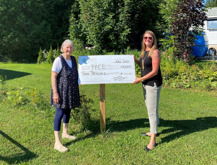 Jennifer presenting a check to PACE