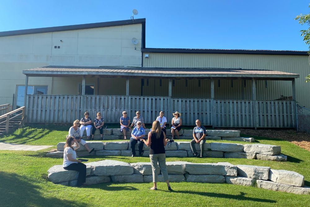Participants of the event sit on the Salvation Army amphitheater listening to Jennifer from the Community Foundation